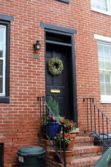 photo of house with trash cans